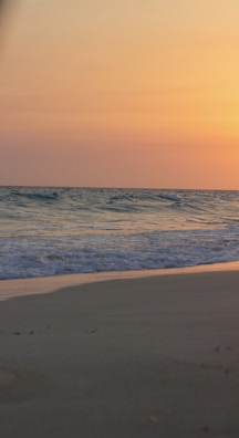 A tranquil beach at sunset, evoking relaxation and peace.