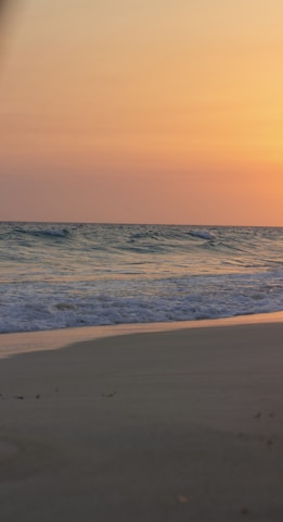 A tranquil beach scene at sunset, evoking relaxation and serenity.