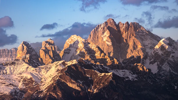 A stunning close-up of icy mountain peaks glowing under soft morning light.