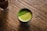 A happy customer enjoying a cup of green tea.