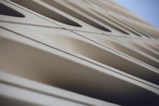 8k close-up of refined dark architectural textures symbolizing precision and care.