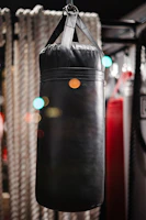 Electric punching bag machine glowing softly in a home gym setting.