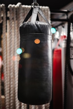 A welcoming boxing gym entrance with gloves hanging by the door under soft lighting.