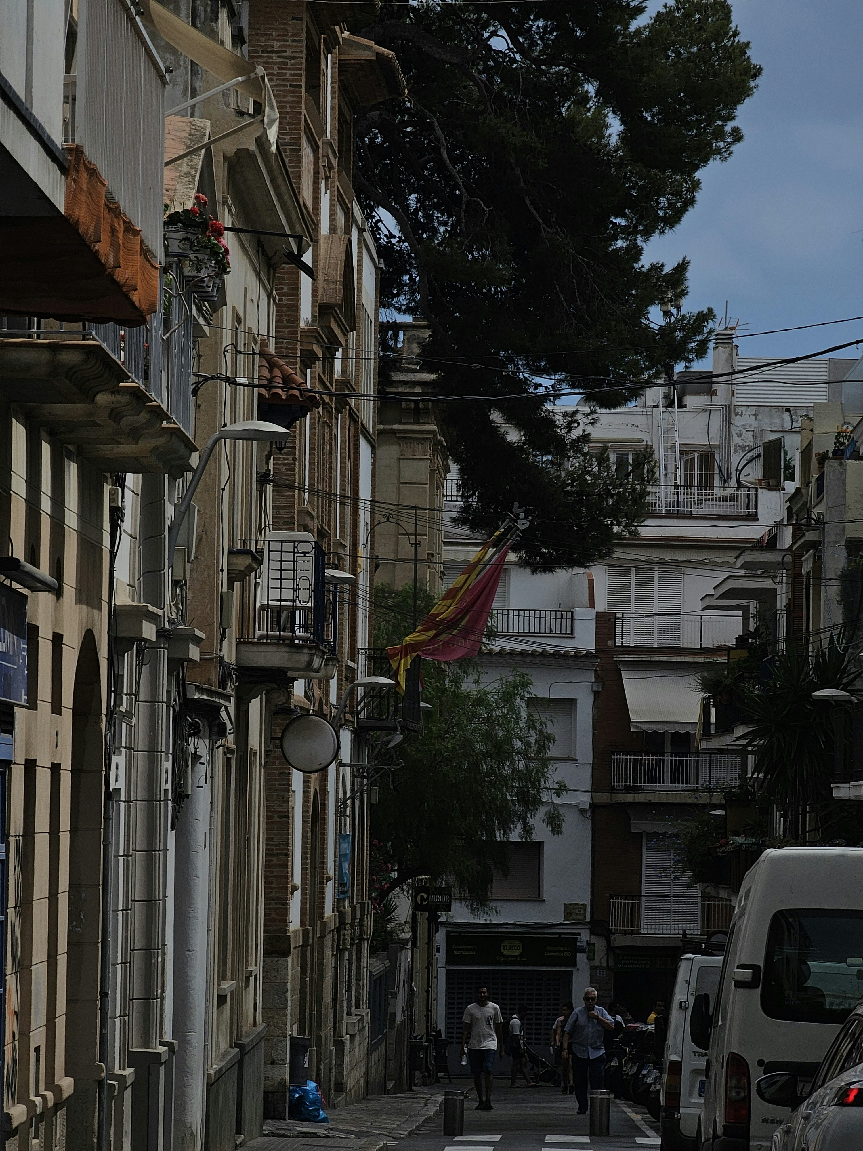 a city street with people walking down it