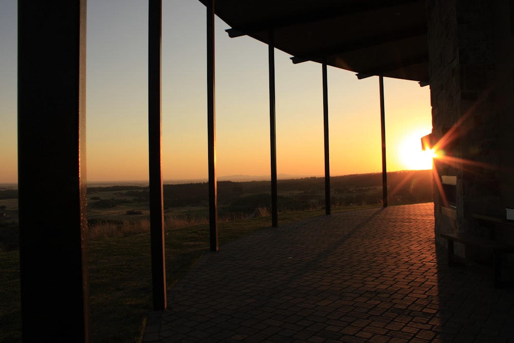 the sun is setting over the horizon of a field