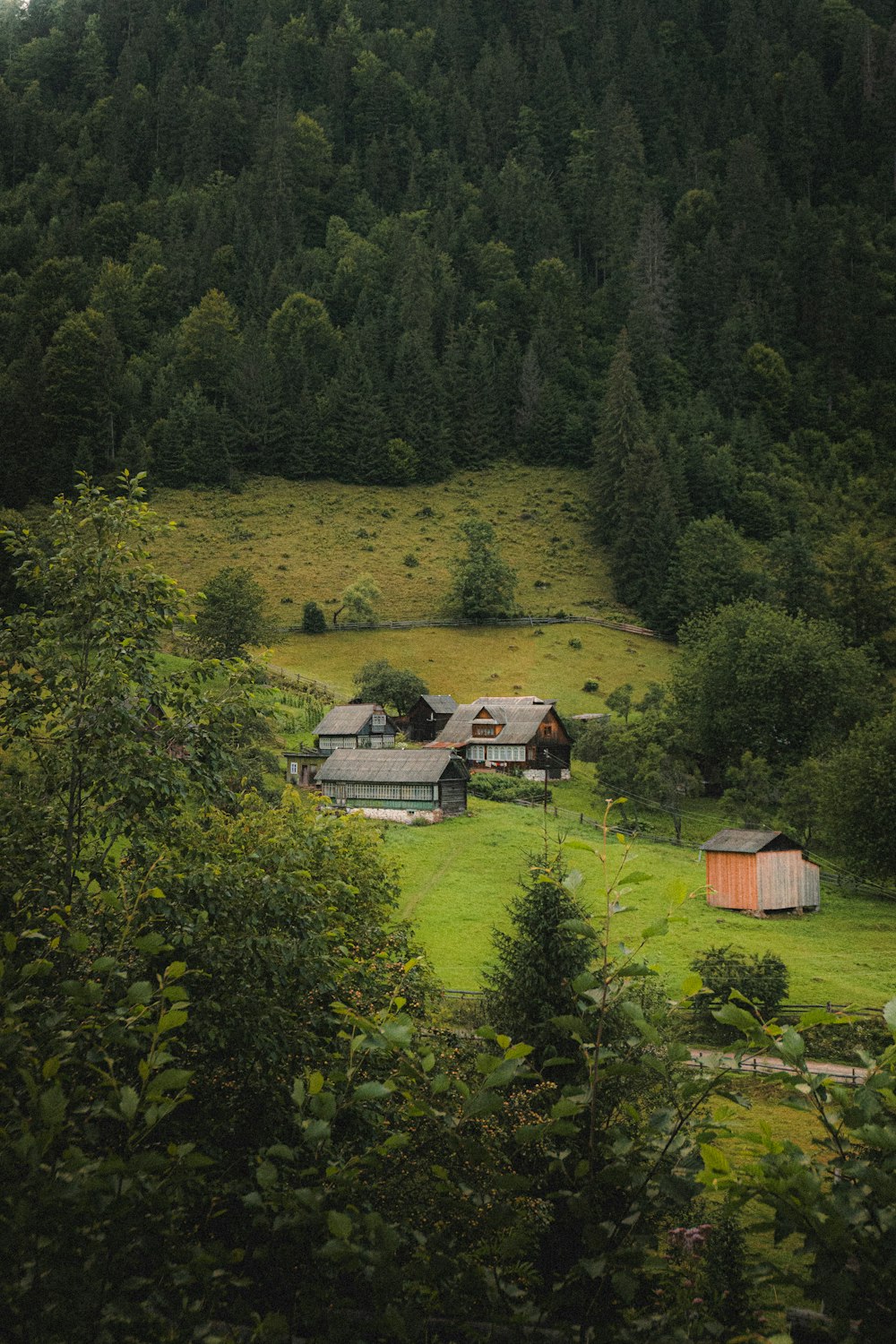 a green field with a house in the middle of it