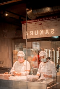 Chef expertly preparing momos in a vibrant kitchen setting.