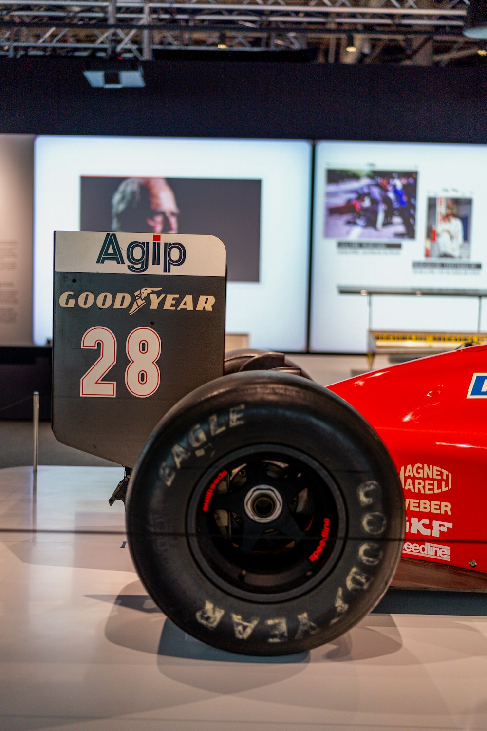 a red race car on display in a museum