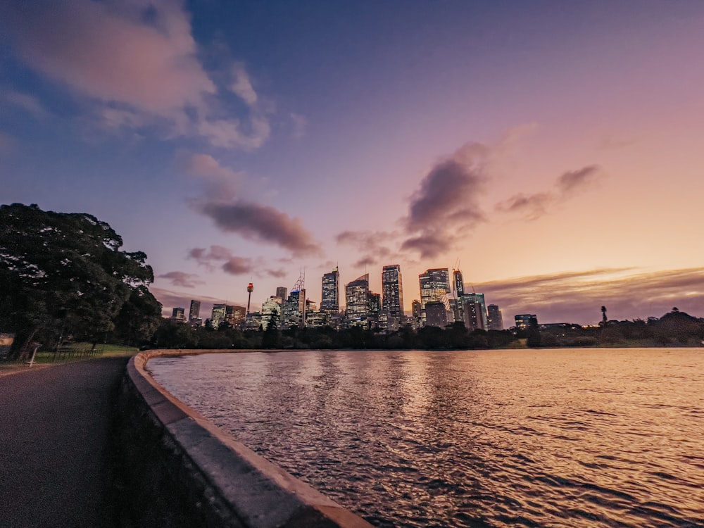 a body of water with a city in the background