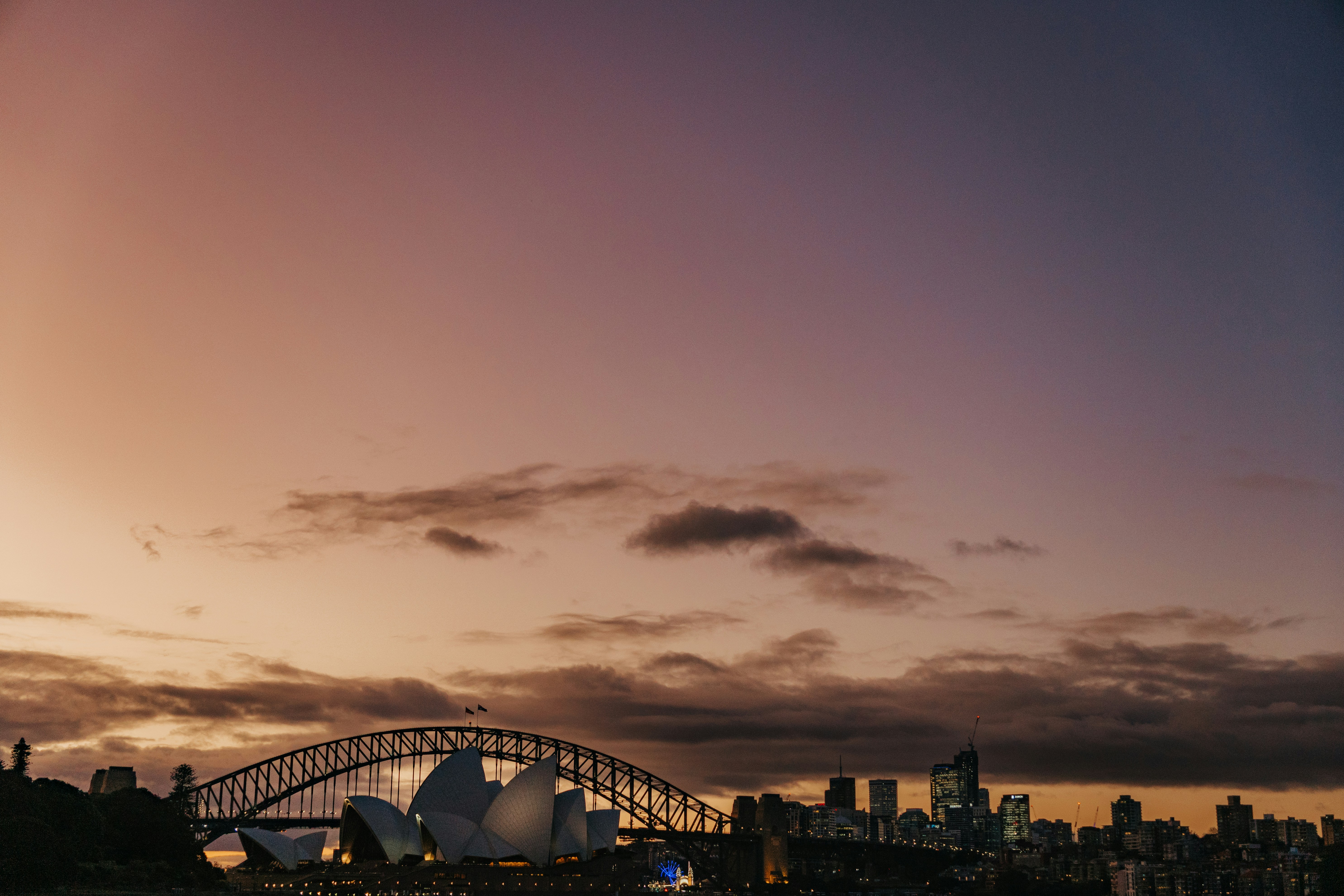 a large bridge over a body of water with a city in the background