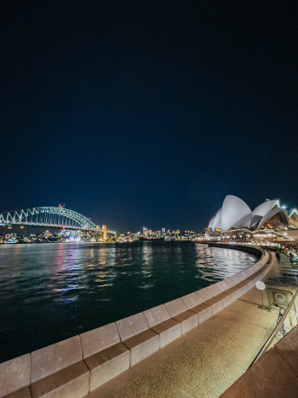 a view of the sydney opera and the sydney bridge at night