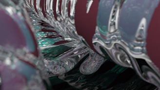 Abstract composition featuring a series of smooth, reflective surfaces with intricate patterns. The design includes swirling forms and curves that give a sense of motion and depth. The surfaces appear to have a metallic or glass-like finish.