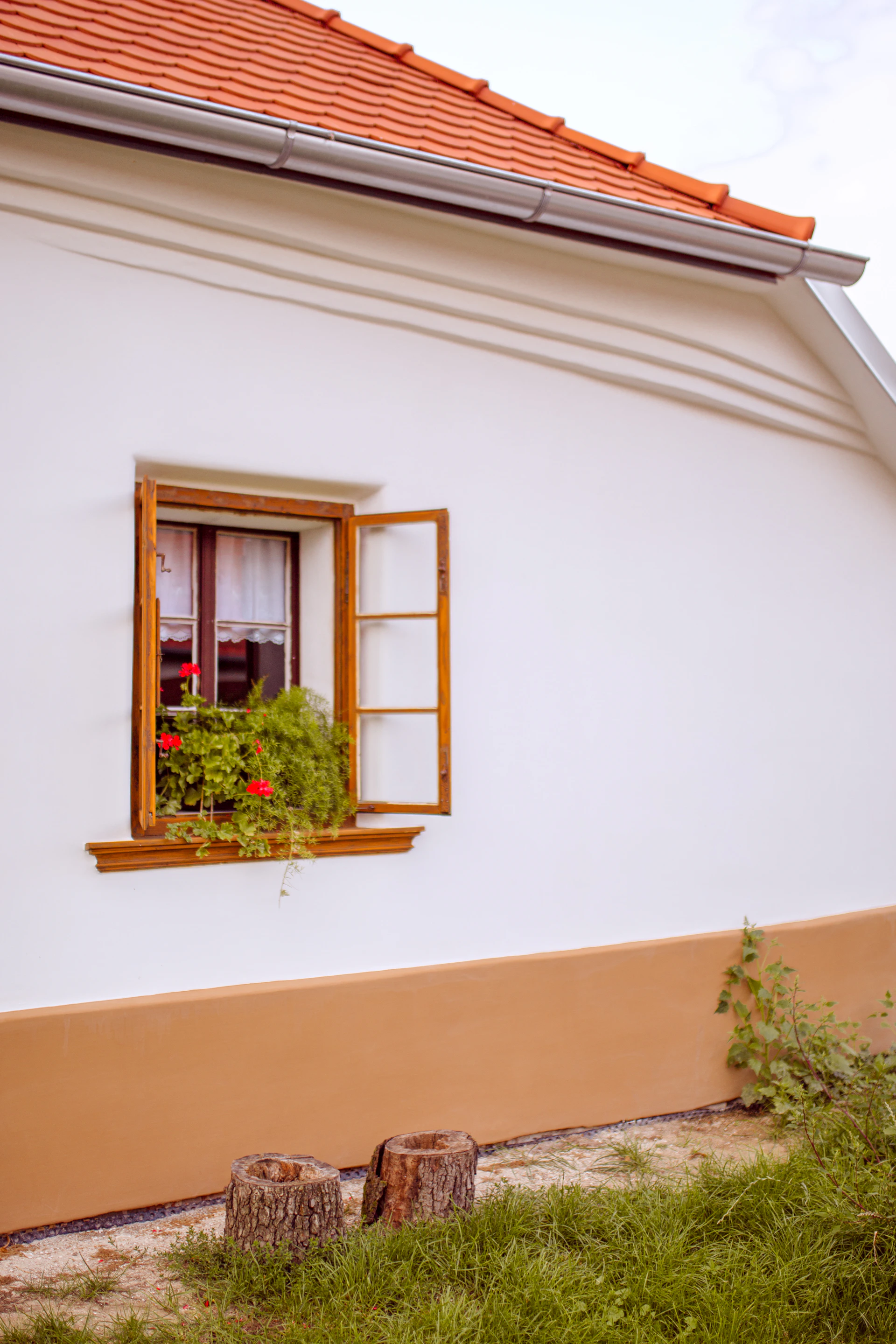 a white house with a red roof and window