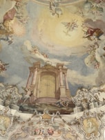 A monumental fresco inside a church, blending spiritual light and celestial motifs in warm tones.