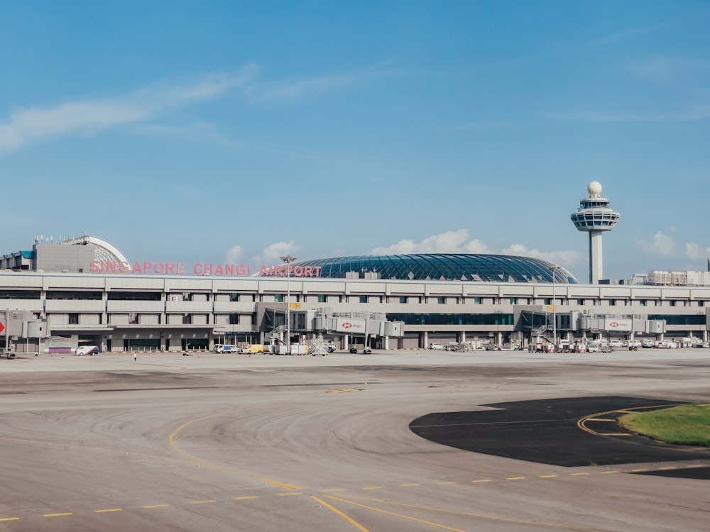 an airport with a control tower in the background