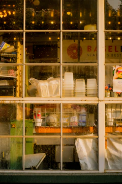 A sparkling clean storefront window with the Santa Cruz Window Shine logo in the corner