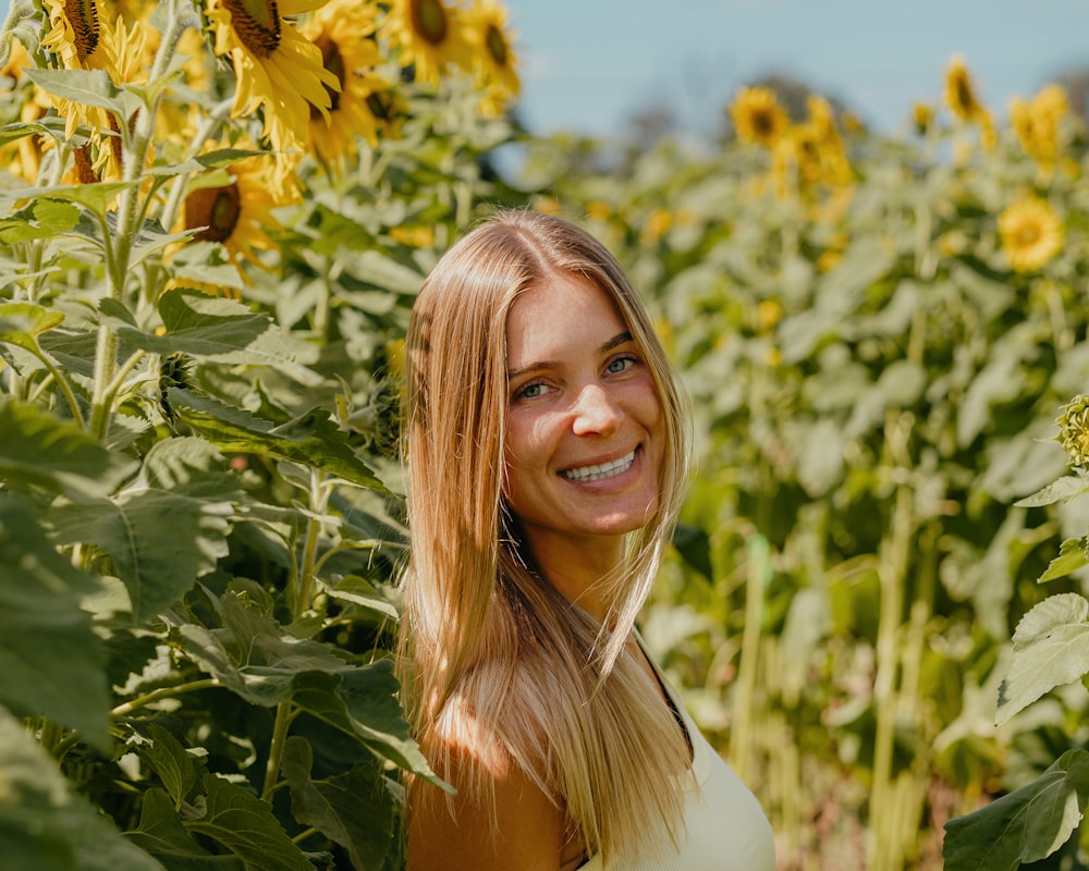 a woman standing in a field of sunflowers