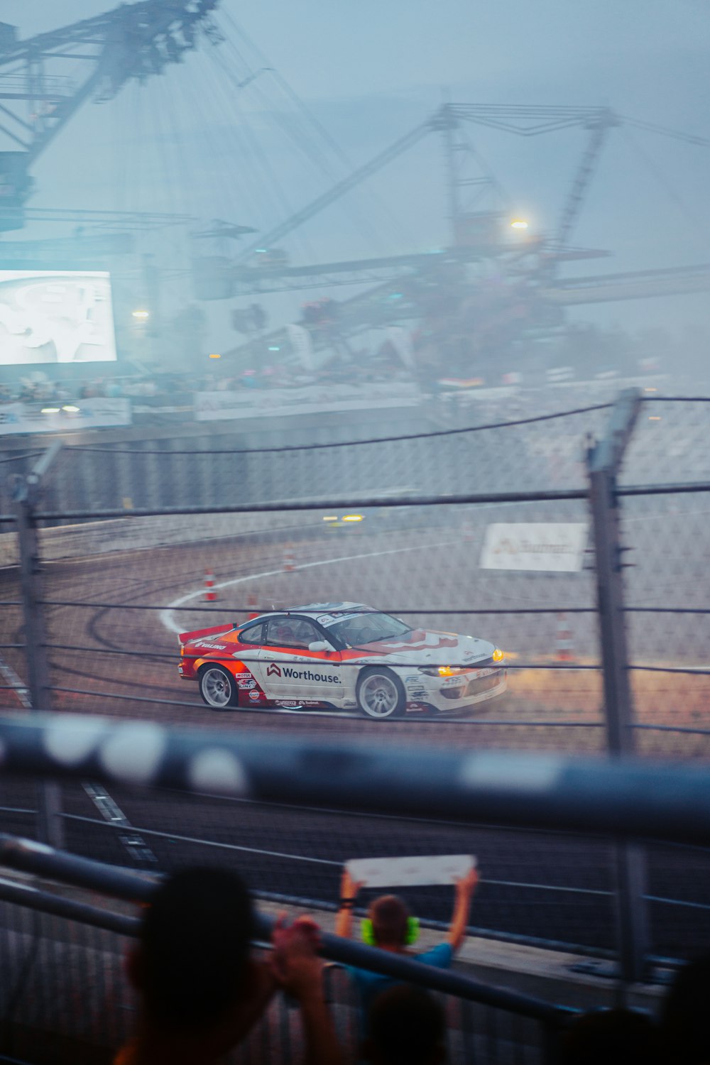 a car driving on a track in the rain