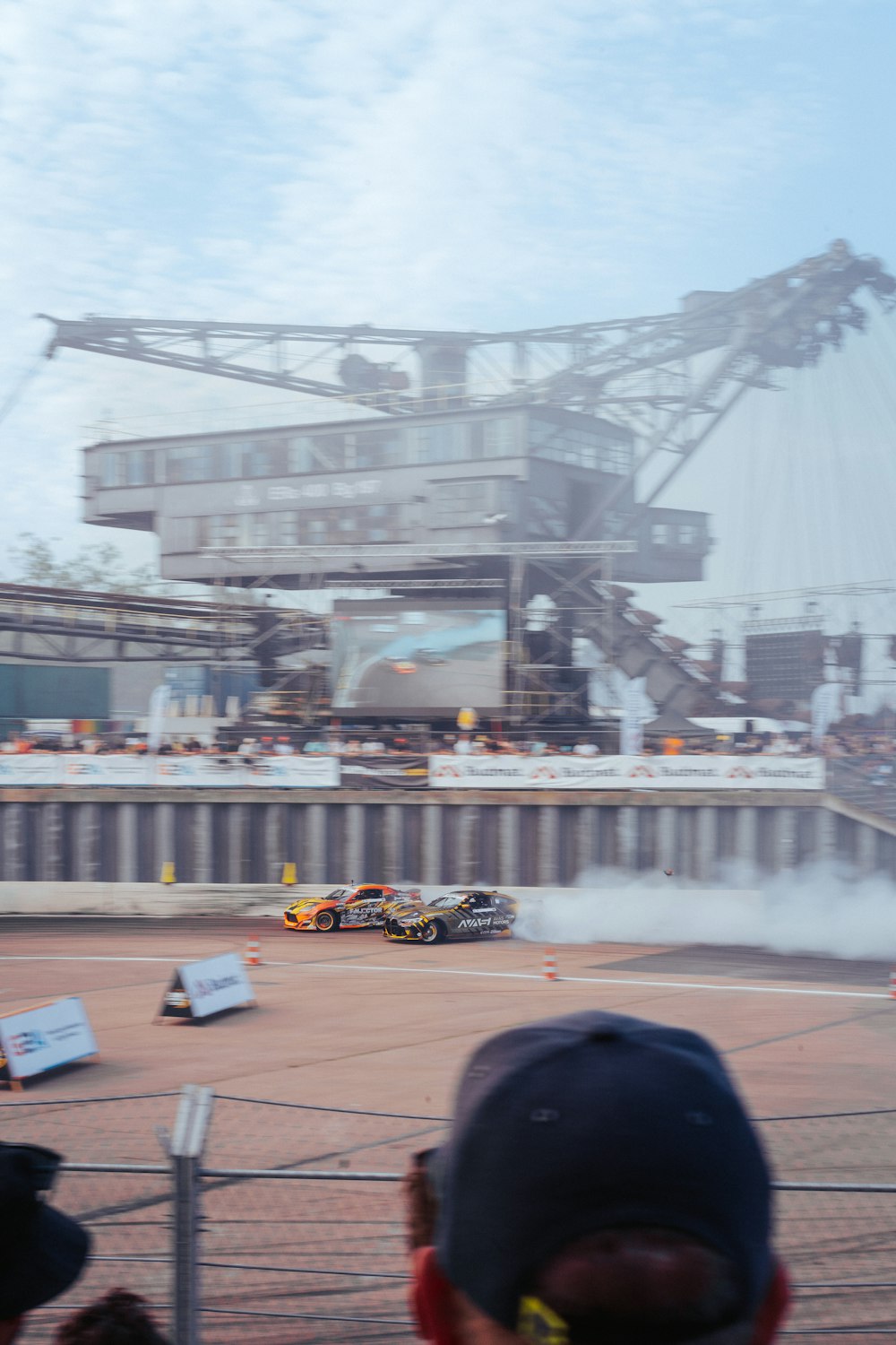 a group of people watching a race on a track