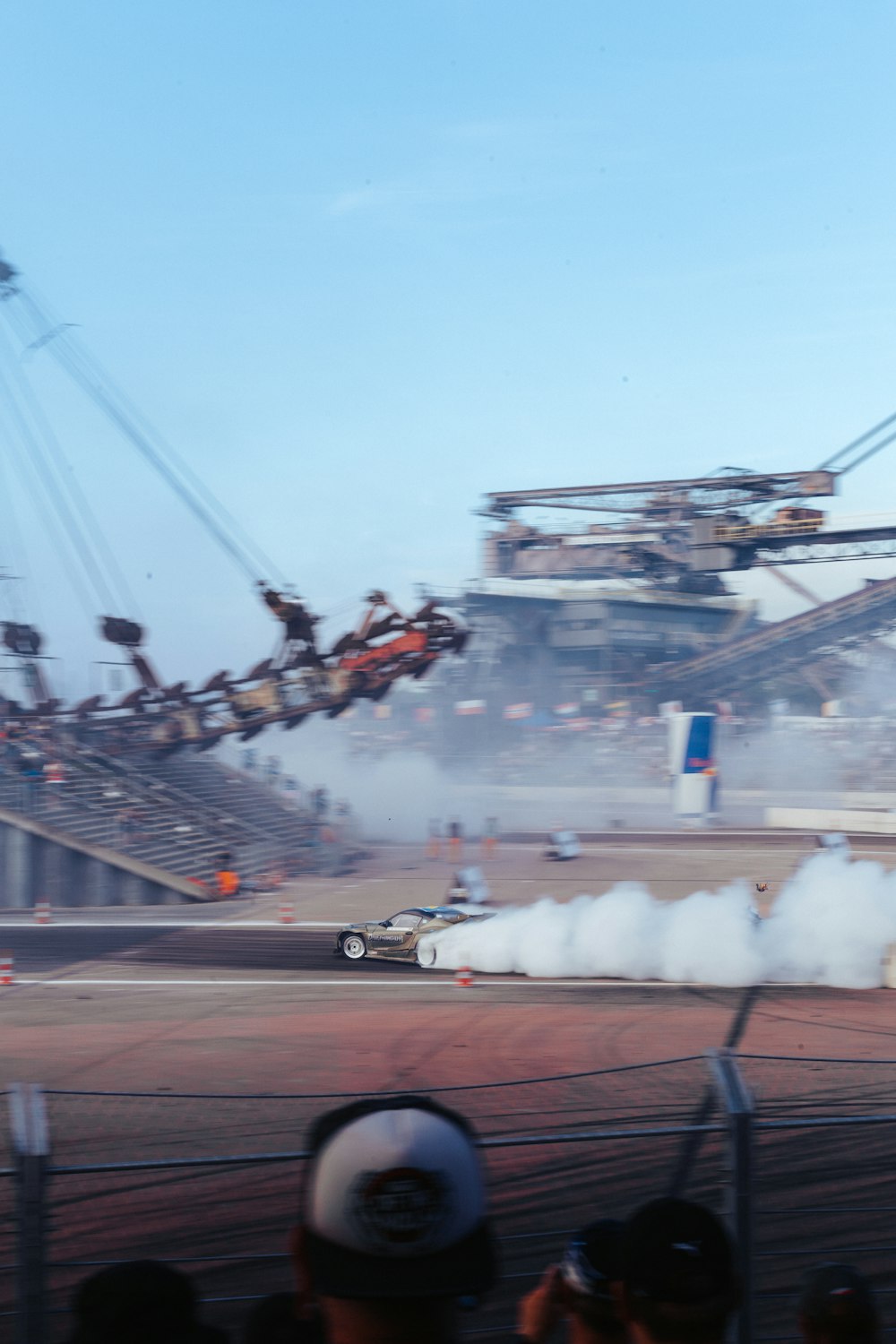 a group of people watching a car burn on a track