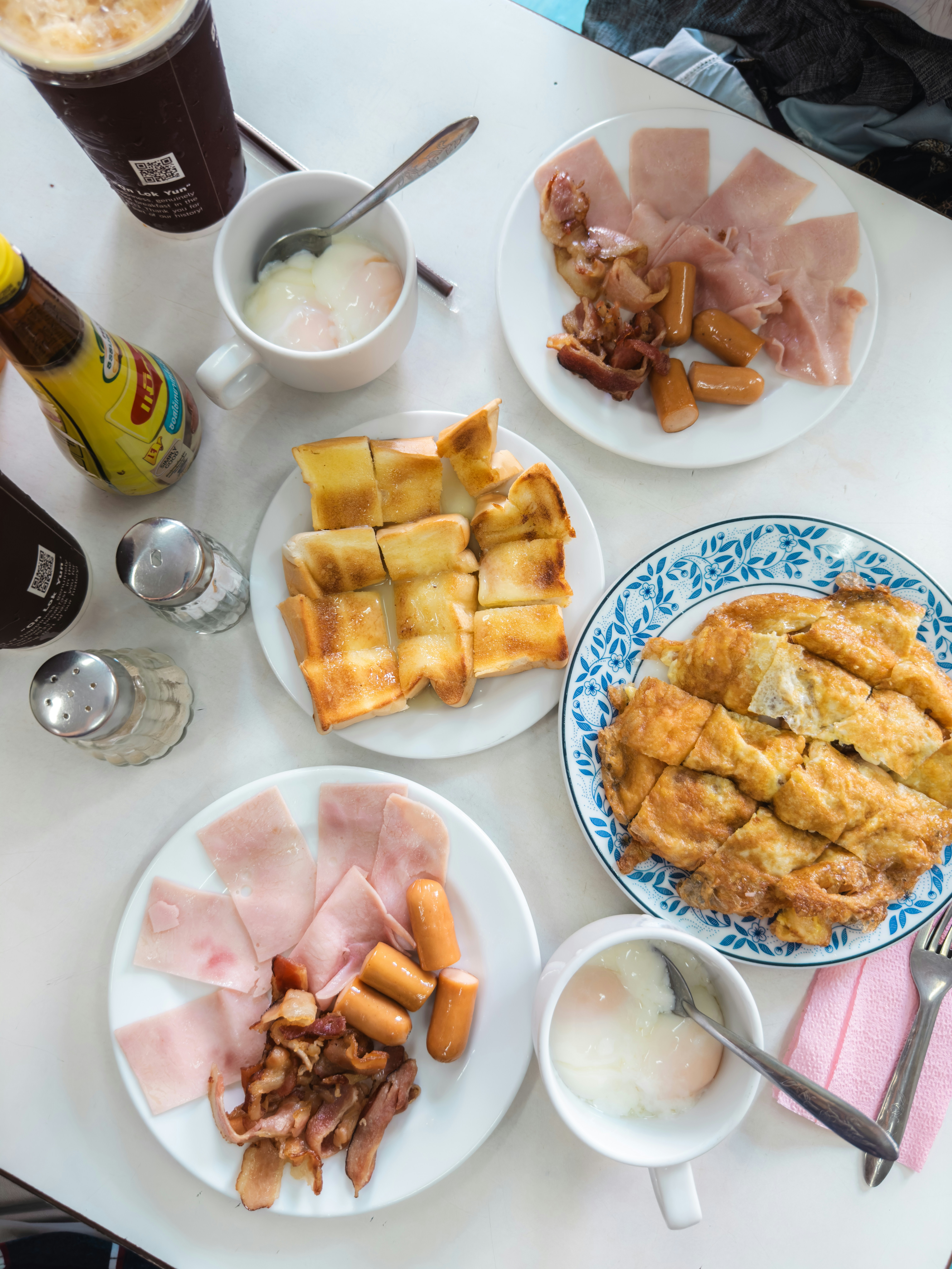 a table topped with plates of food and drinks