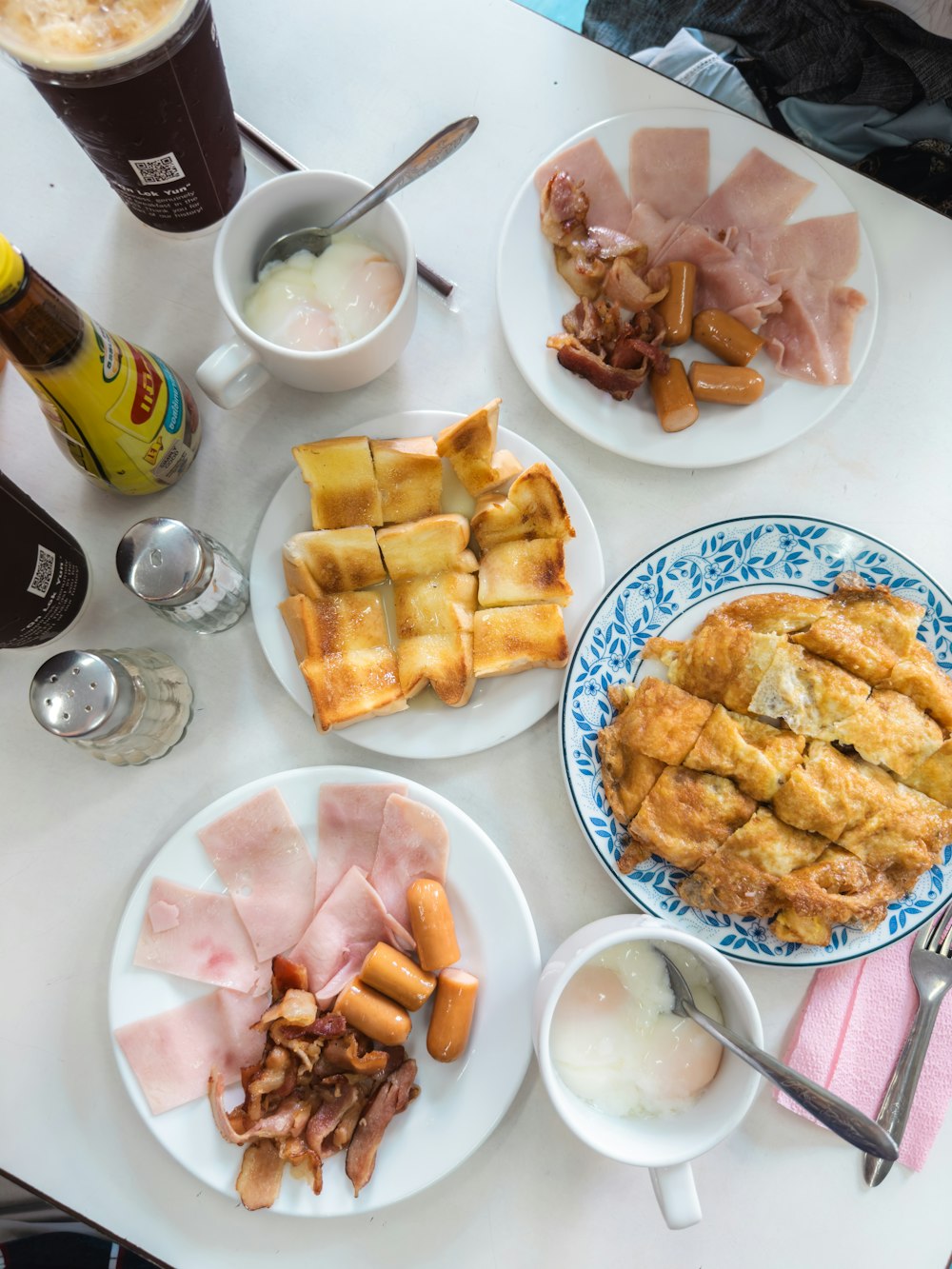 a table topped with plates of food and drinks