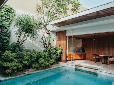 Inviting poolside area surrounded by tropical plants at the retreat.