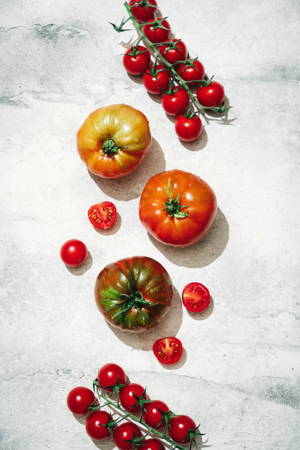 a group of tomatoes sitting on top of a table