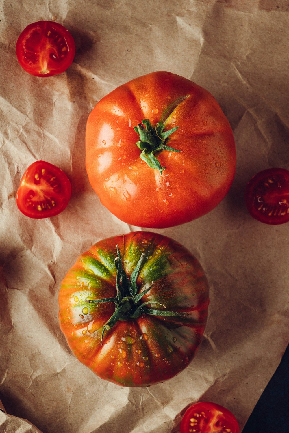 a group of tomatoes sitting on top of a piece of paper
