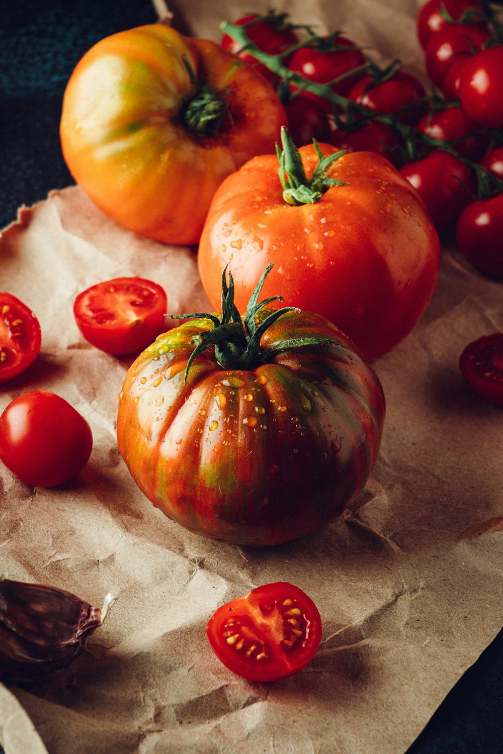 a bunch of tomatoes sitting on top of a piece of paper