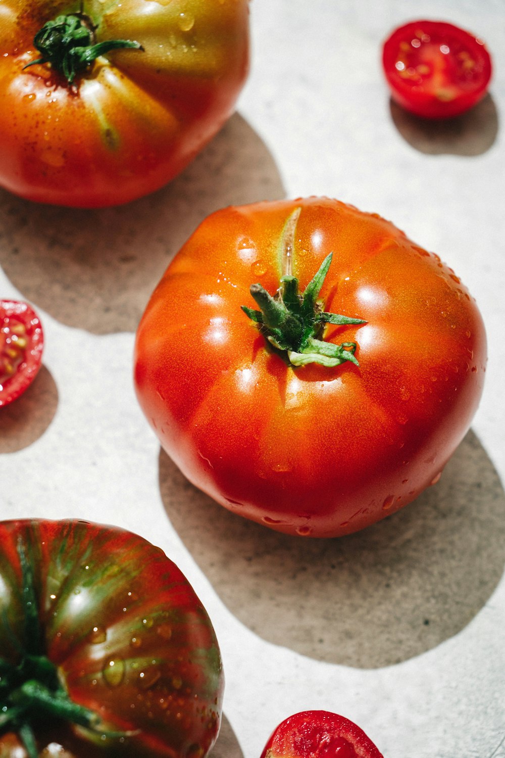 a group of tomatoes sitting on top of a table