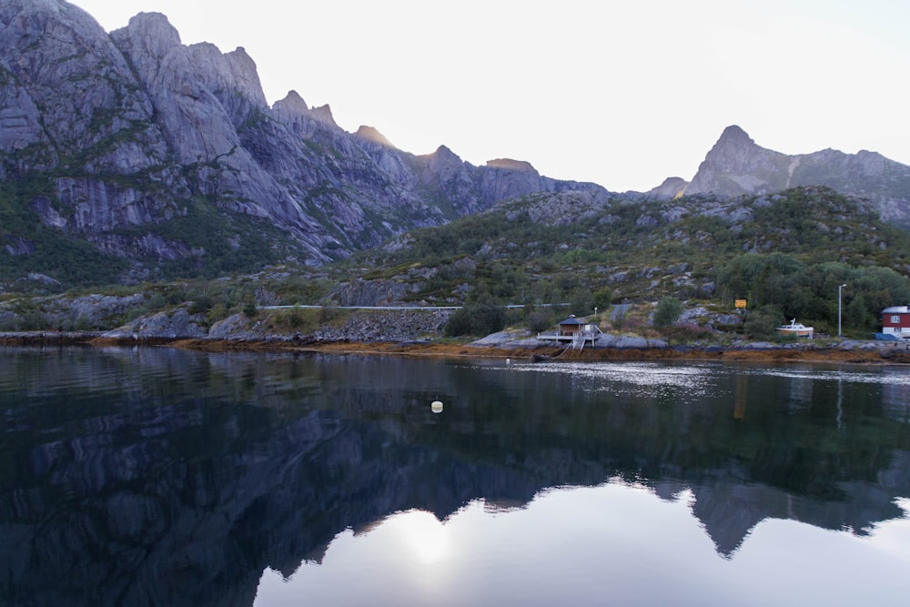 a body of water with mountains in the background