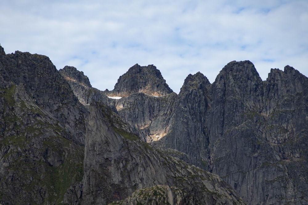 a group of mountains with a blue sky in the background
