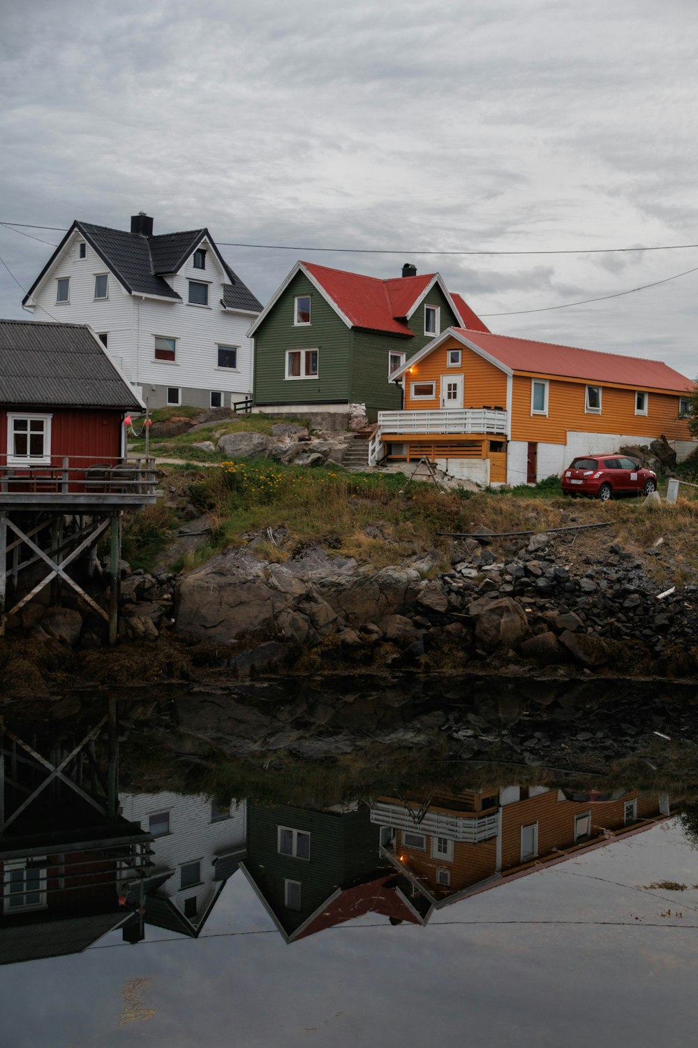 a group of houses sitting next to a body of water