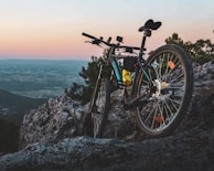 Sunset view over a mountain trail with enduro bikes parked on the side.