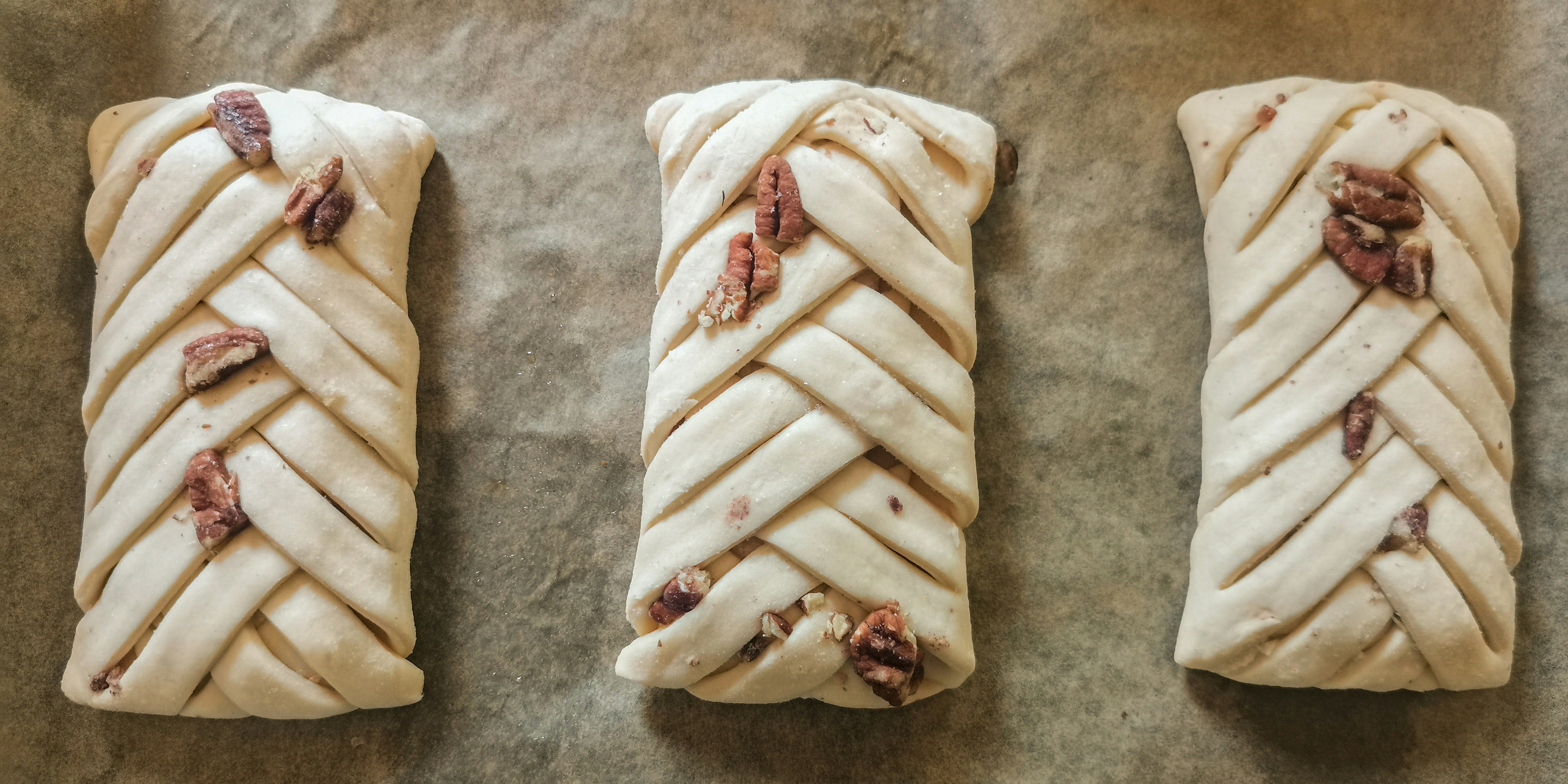 a close up of three pastry items on a table