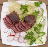 a white plate topped with meat and veggies