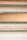 Several stacked books showing their aged and textured spines and pages, varying in color from shades of cream to light brown. Each book is bound with a greenish cover, hinting at their vintage nature.
