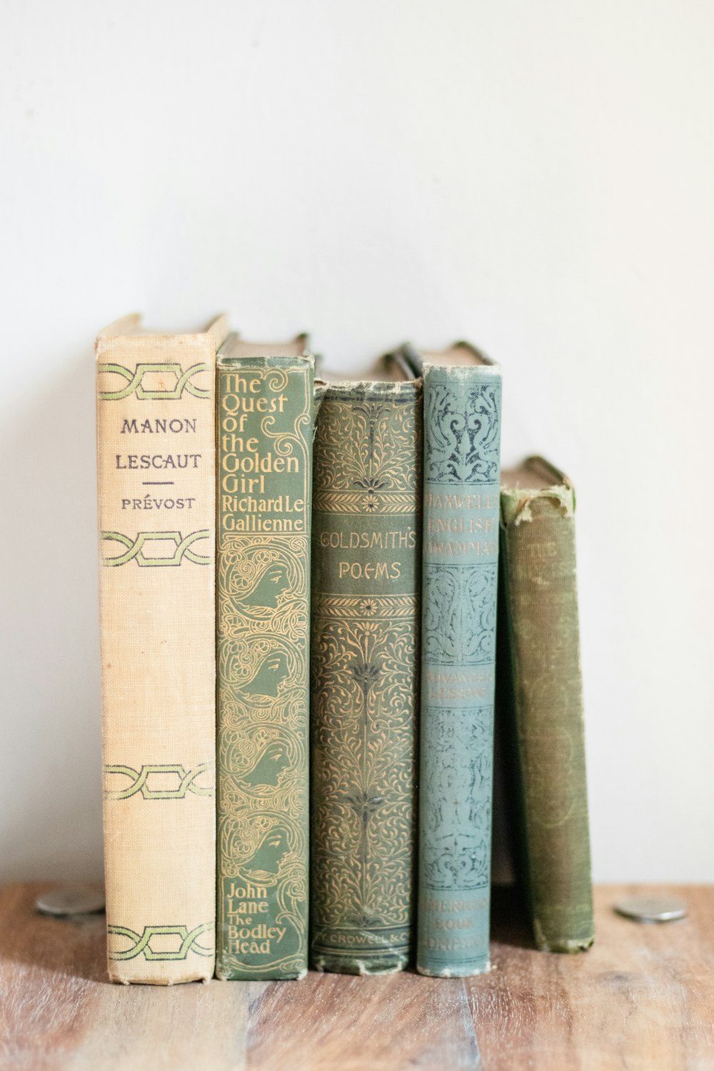 a row of books sitting on top of a wooden table