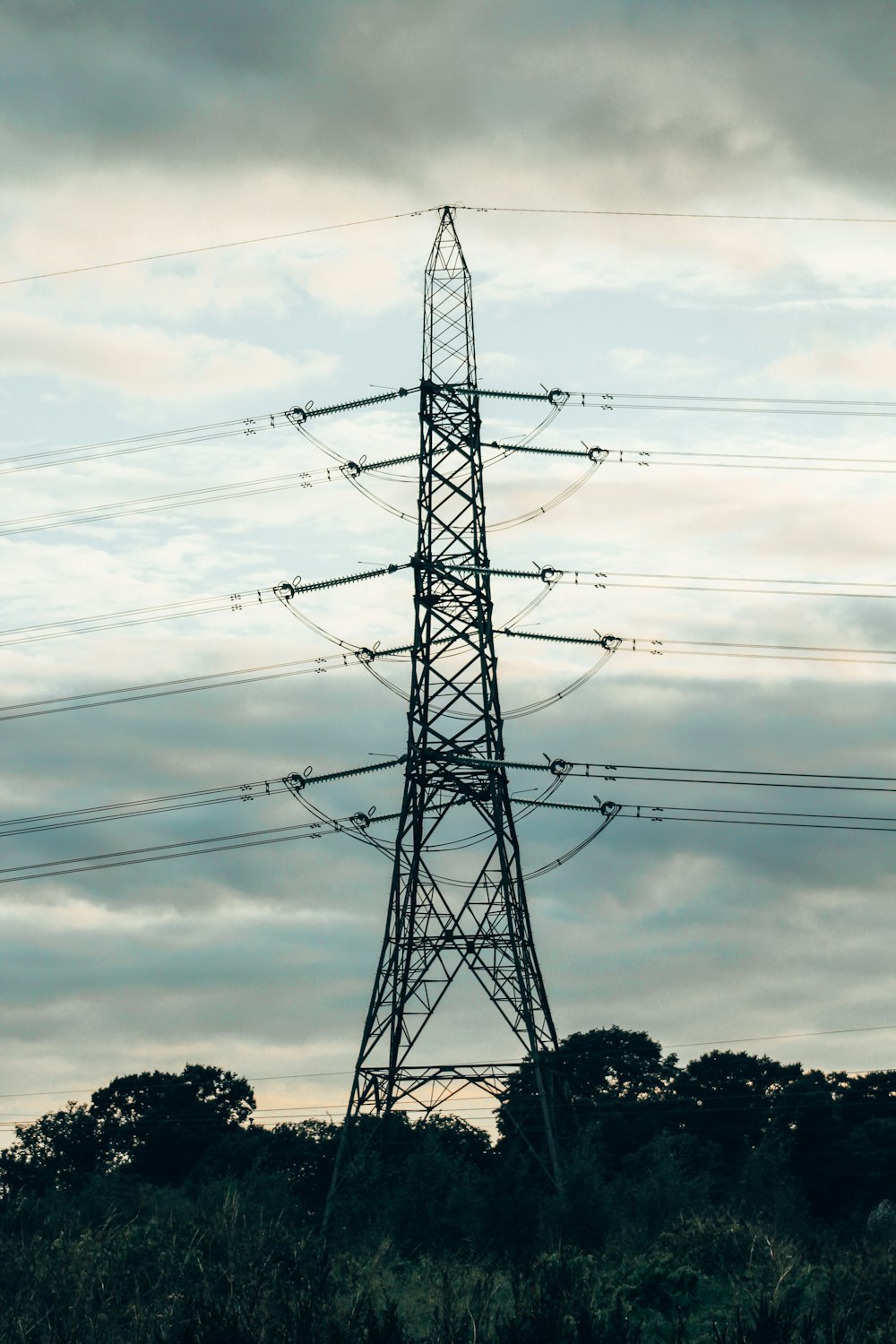 a high voltage power line in the middle of a field