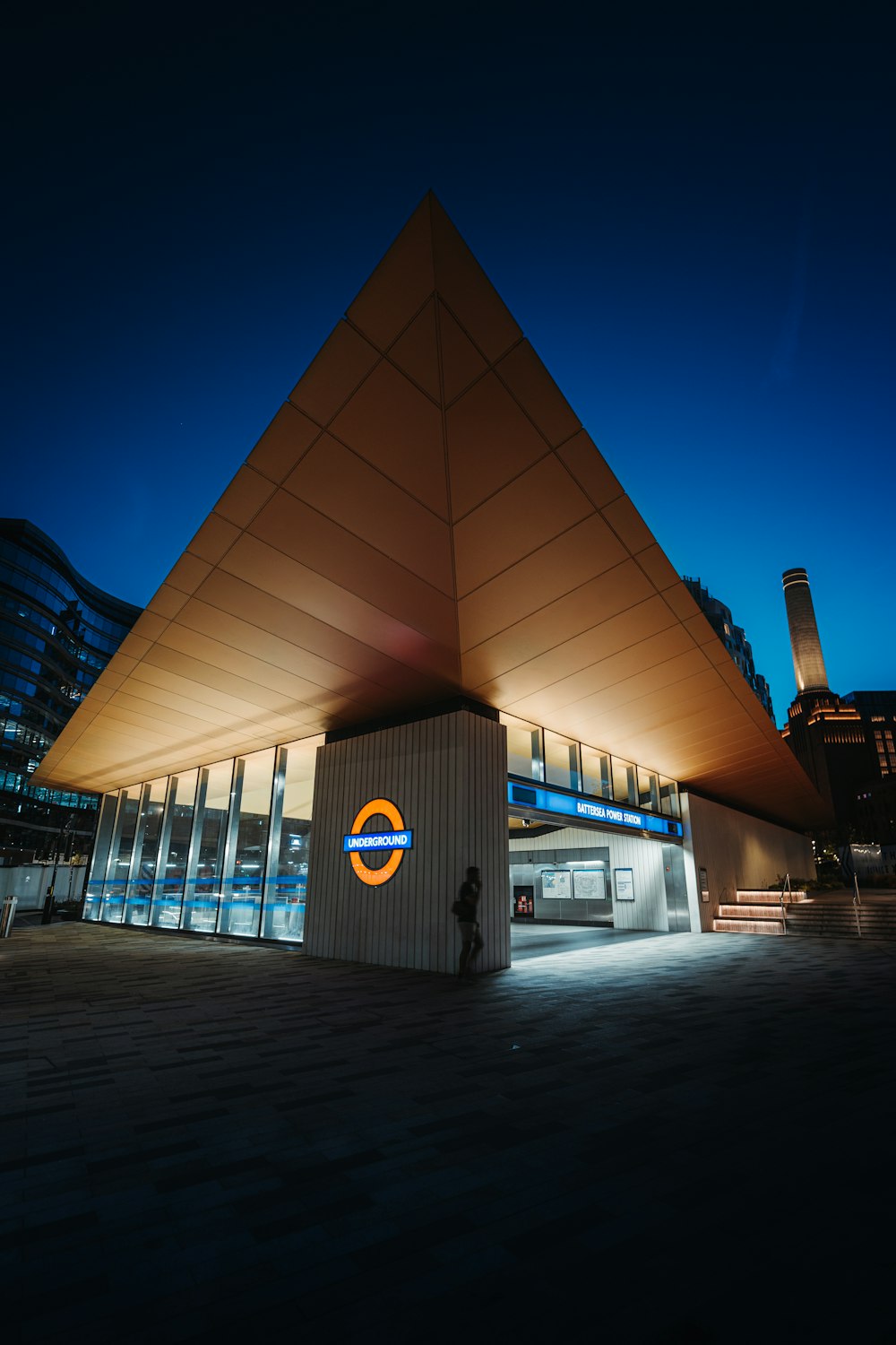 a building with a triangular roof at night