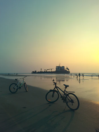 Scenic view of rental bikes lined up near the beach road in Puri at sunset.