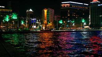 A vibrant Miami beach scene at sunset with lively crowds and colorful lights reflecting the city's energetic entertainment vibe.