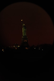 An inviting image of the Statue of Liberty bathed in soft earthy light.