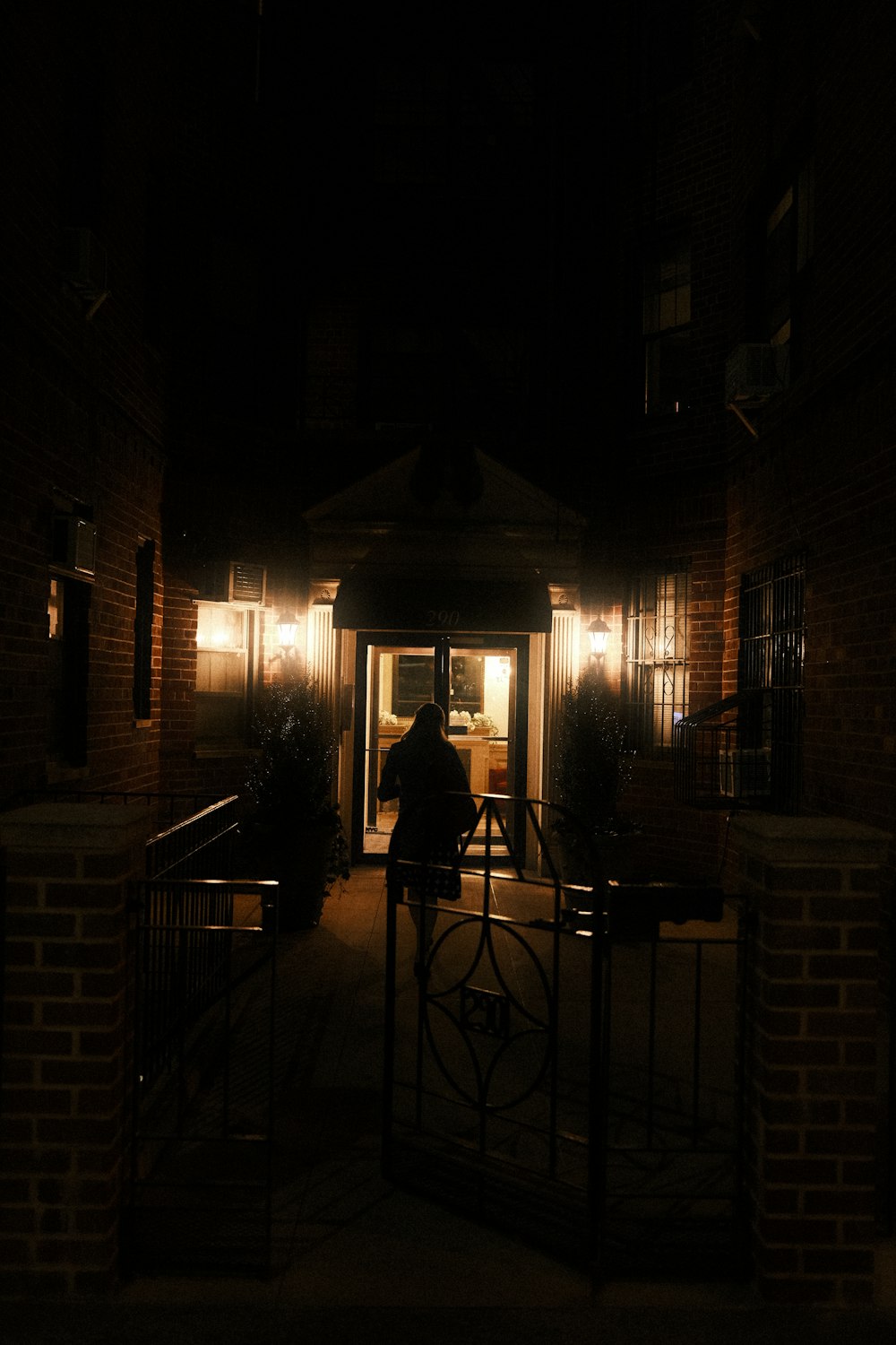 a man standing in front of a doorway at night