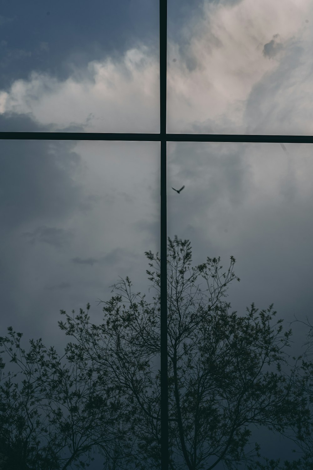 a cross is seen through the window of a building