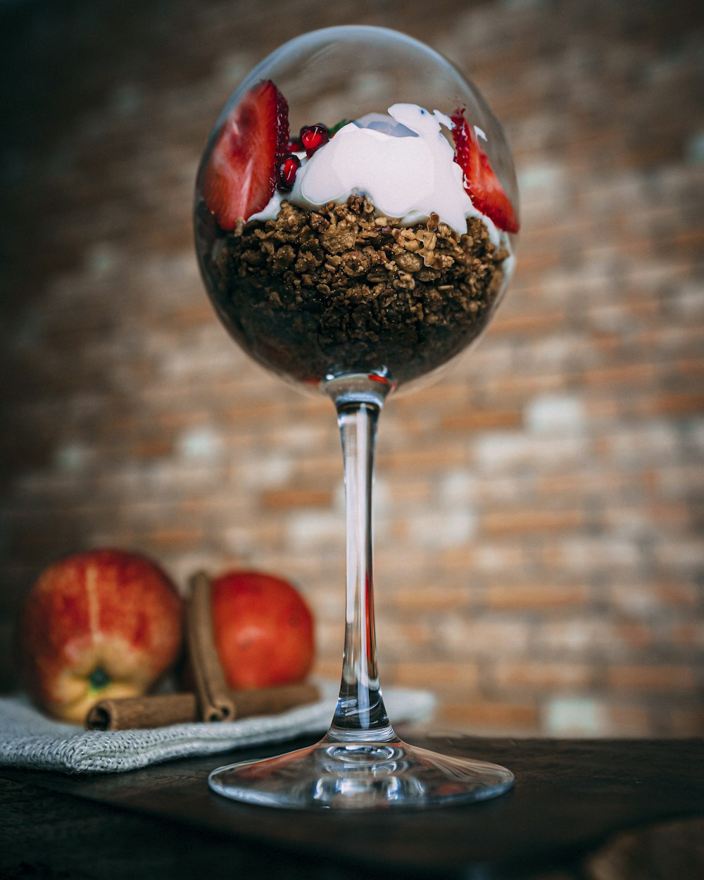 a dessert in a wine glass on a table