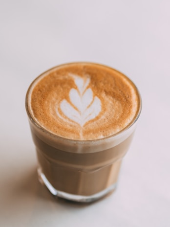 An artistic swirl of latte art resembling a flower.