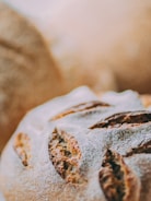 Close-up of a chef preparing artisanal bread in a bakery kitchen.