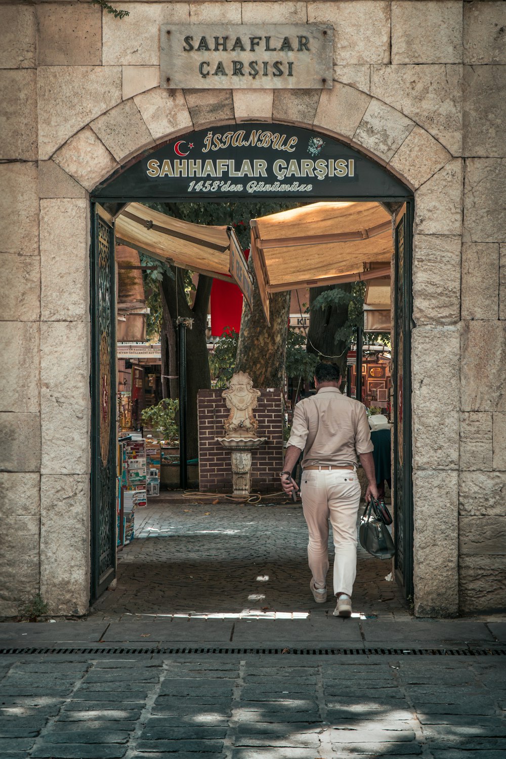 a man is walking out of a store